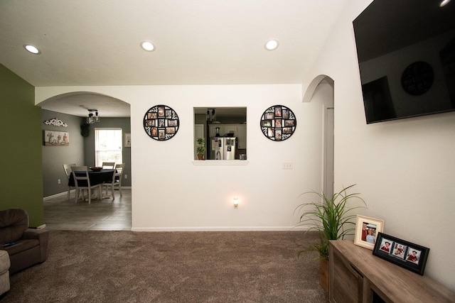 interior space with carpet floors, arched walkways, baseboards, and recessed lighting