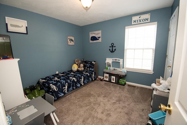 bedroom with baseboards and carpet