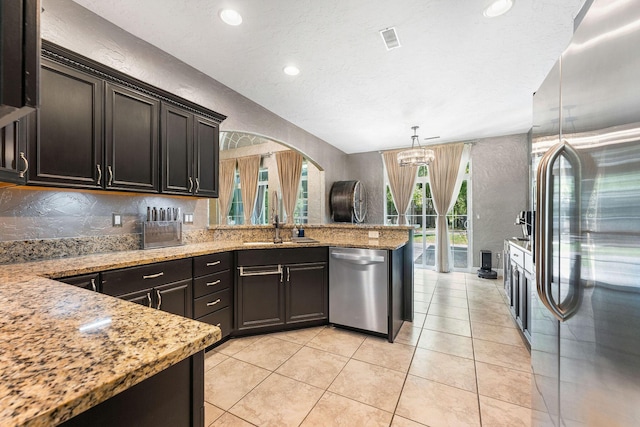 190 Windy Ridge Dr, Hollister, MO 65672 - kitchen with light stone counters, visible vents, a peninsula, a chandelier, and appliances with stainless steel finishes