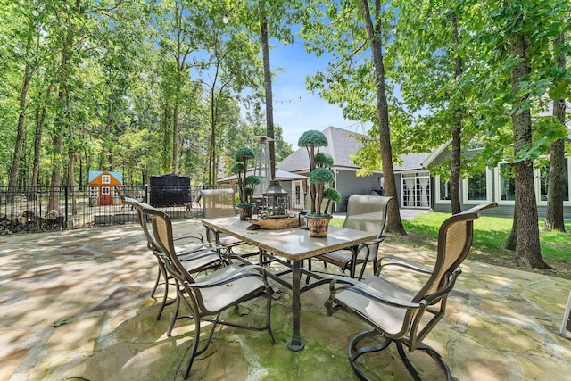 190 Windy Ridge Dr, Hollister, MO 65672 - view of patio / terrace featuring fence, outdoor dining area, and french doors