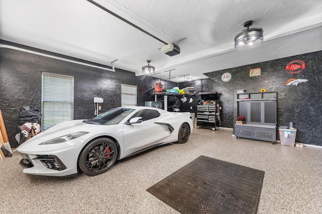190 Windy Ridge Dr, Hollister, MO 65672 - garage featuring baseboards and a garage door opener