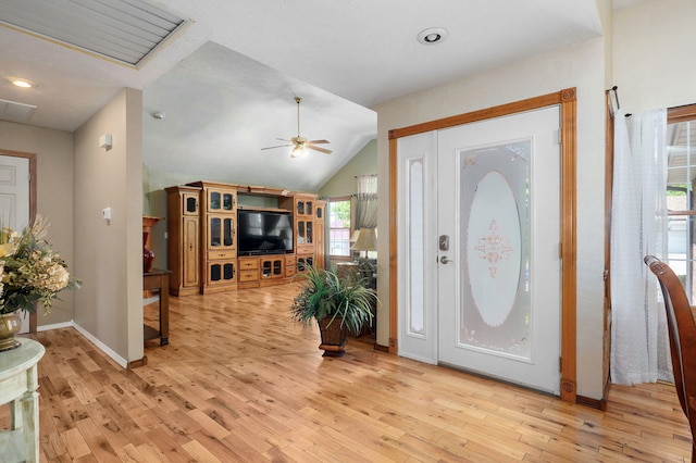 foyer with light wood-type flooring, visible vents, baseboards, ceiling fan, and lofted ceiling
