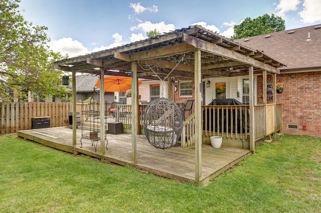 wooden deck featuring fence and a lawn