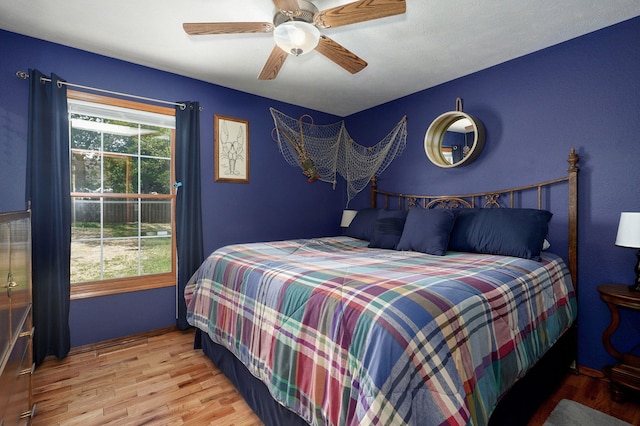 bedroom with ceiling fan and wood finished floors
