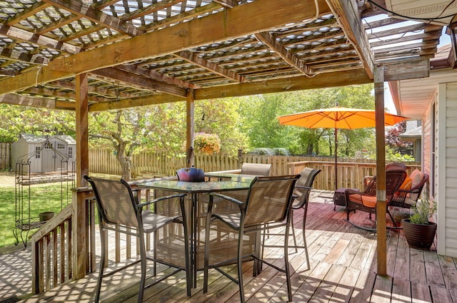 wooden terrace with outdoor dining space, a pergola, a storage shed, and a fenced backyard