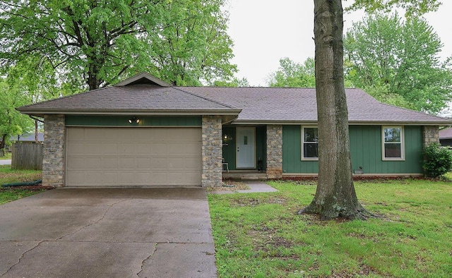 ranch-style house with concrete driveway, roof with shingles, a garage, and stone siding