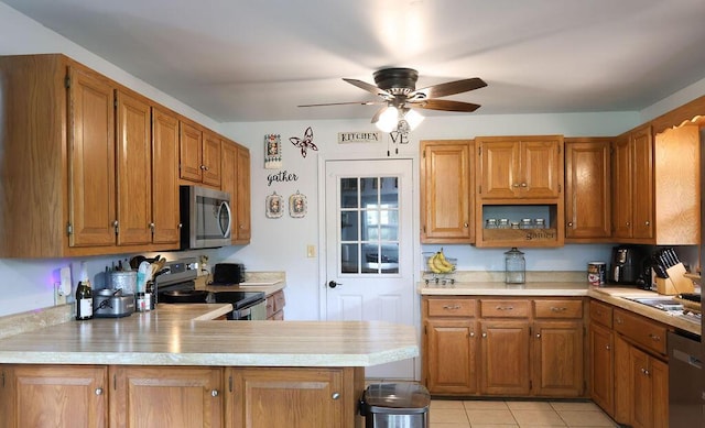 kitchen featuring light countertops, stainless steel appliances, brown cabinets, and ceiling fan