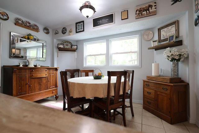 dining space with light tile patterned floors and a healthy amount of sunlight