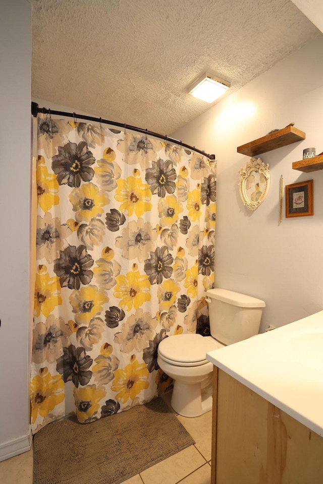 bathroom with toilet, tile patterned floors, curtained shower, a textured ceiling, and vanity