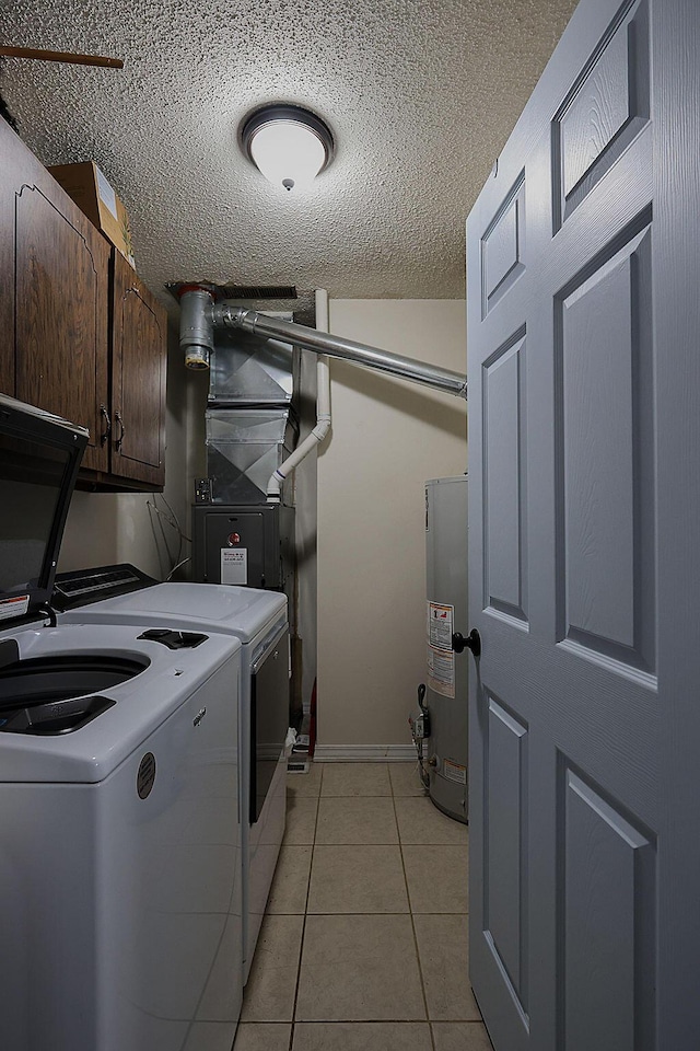 clothes washing area featuring cabinet space, independent washer and dryer, water heater, a textured ceiling, and light tile patterned floors