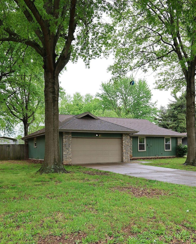 single story home featuring an attached garage, driveway, fence, and stone siding