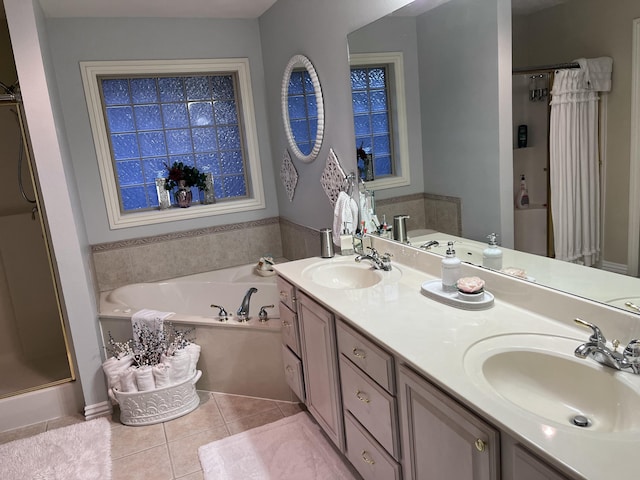 full bathroom with a sink, a garden tub, a shower stall, and tile patterned floors