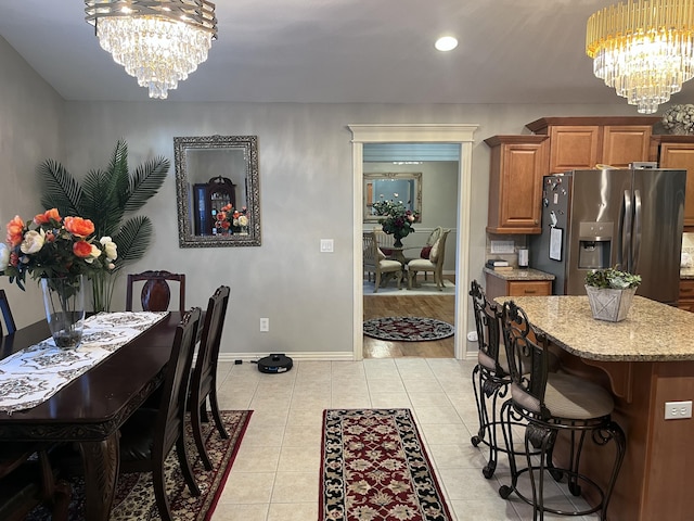 dining area with light tile patterned floors, a chandelier, baseboards, and recessed lighting