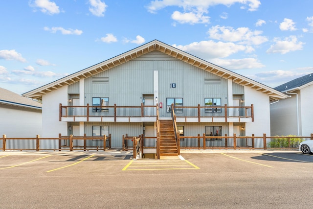403 Veterans Blvd Unit 203 G6, Branson, MO 65616 - view of front facade with a balcony, board and batten siding, uncovered parking, and stairs