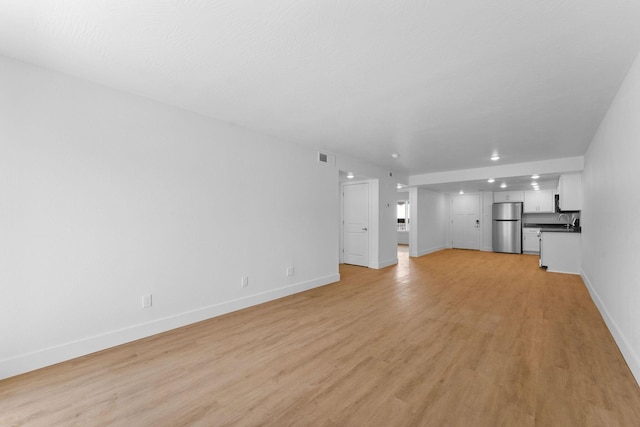 403 Veterans Blvd Unit 203 G6, Branson, MO 65616 - unfurnished living room with light wood-style floors, visible vents, baseboards, and recessed lighting