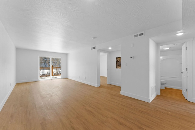 403 Veterans Blvd Unit 203 G6, Branson, MO 65616 - unfurnished living room with light wood finished floors, baseboards, and visible vents