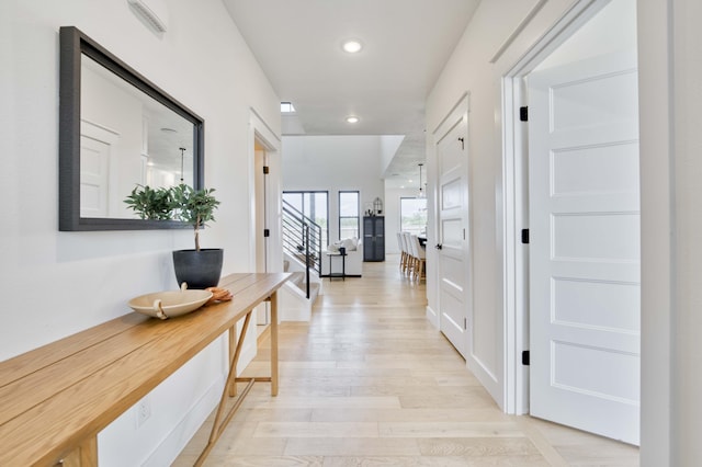 corridor featuring light wood-style flooring and recessed lighting