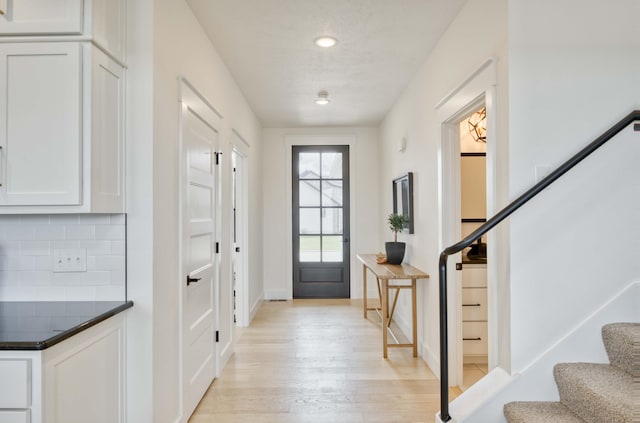 doorway to outside with stairway, light wood-style flooring, baseboards, and recessed lighting
