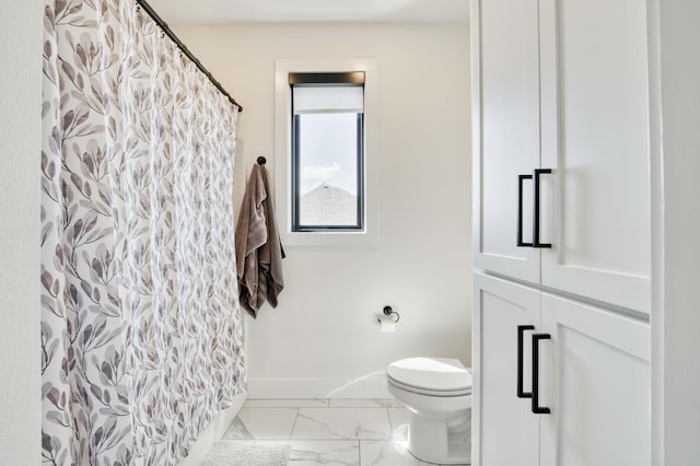 bathroom featuring baseboards, marble finish floor, toilet, and curtained shower