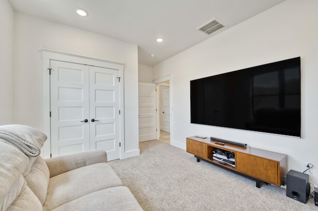 carpeted living area with baseboards, recessed lighting, and visible vents