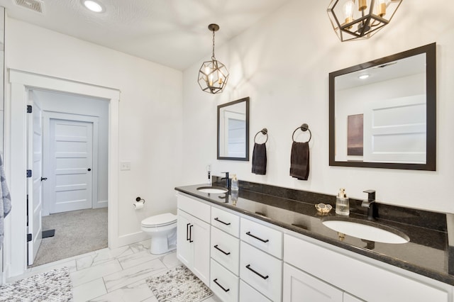 bathroom featuring an inviting chandelier, toilet, a sink, visible vents, and marble finish floor