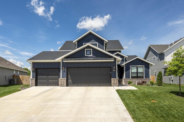 craftsman house with an attached garage, fence, a front yard, and board and batten siding