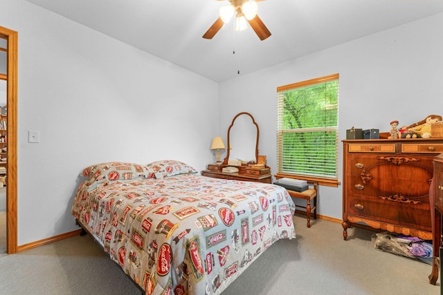 carpeted bedroom featuring baseboards and a ceiling fan