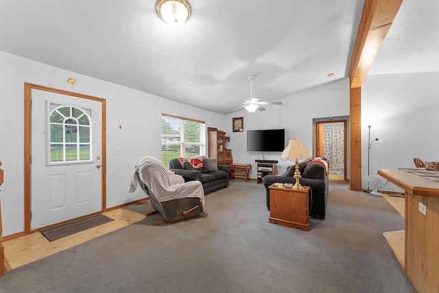 living area featuring vaulted ceiling, baseboards, a ceiling fan, and light carpet