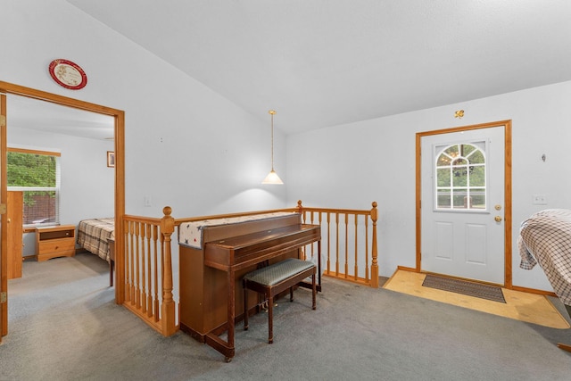 carpeted dining room with lofted ceiling