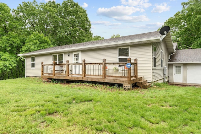 rear view of house with a yard and a wooden deck