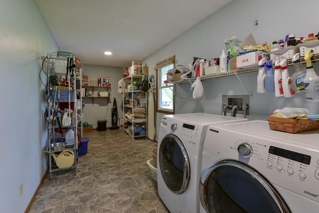 laundry area featuring independent washer and dryer, stone finish floor, and laundry area