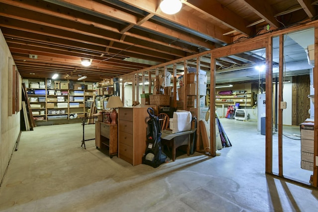 unfinished below grade area featuring water heater