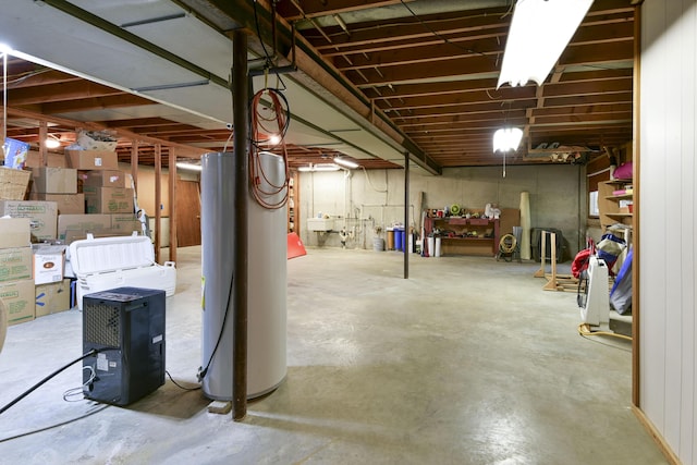 unfinished below grade area with water heater and a sink
