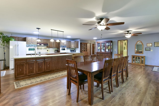 dining space featuring a ceiling fan and wood finished floors