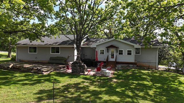 rear view of house with a yard, a patio area, and entry steps