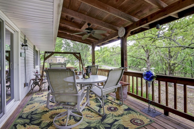 wooden deck featuring ceiling fan and outdoor dining area