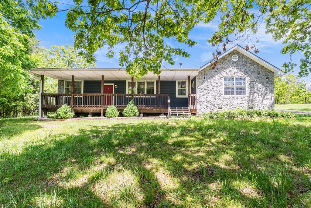 5870 Old 60th Dr, Neosho, MO 64850 - view of front of home featuring stone siding and a deck