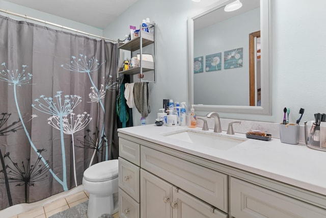 bathroom with toilet, tile patterned floors, vanity, and curtained shower
