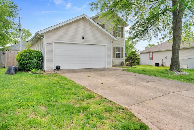 view of front facade with a front lawn, a garage, fence, and concrete driveway
