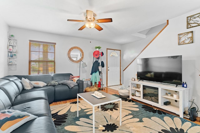 living area with ceiling fan and wood finished floors