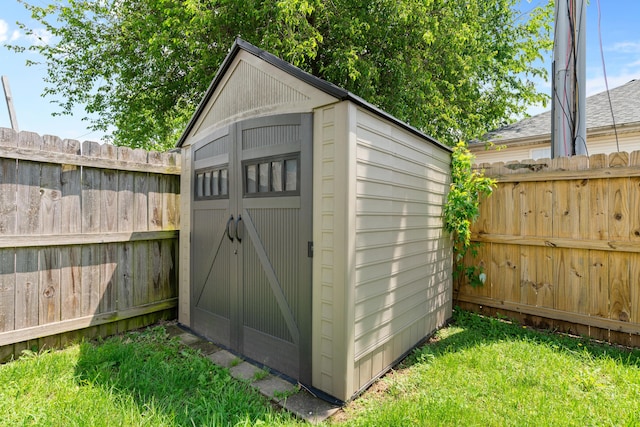view of shed with a fenced backyard