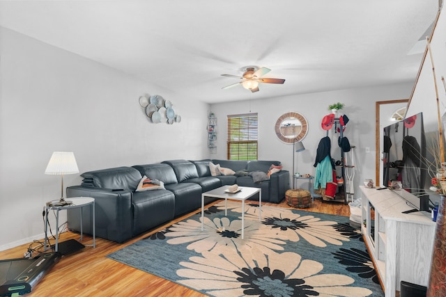 living area with light wood-style floors and ceiling fan