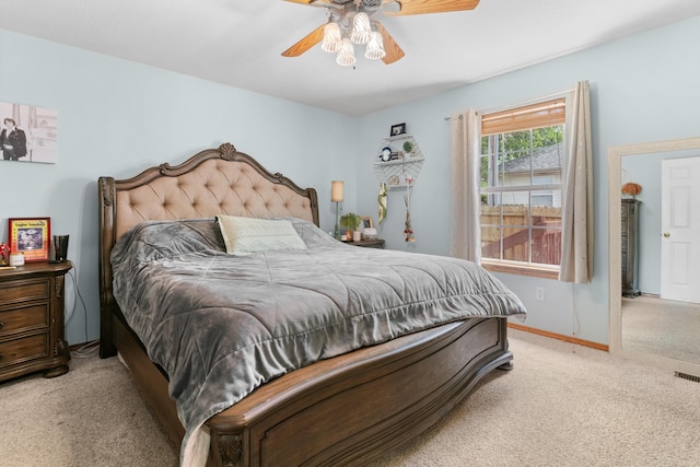 bedroom with light colored carpet, baseboards, ceiling fan, and visible vents