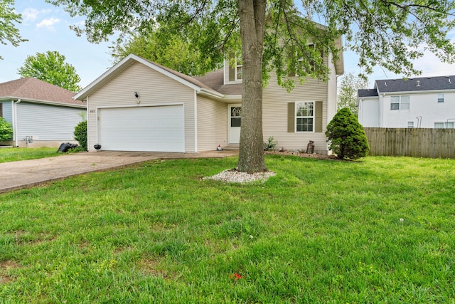traditional-style house featuring a front yard, fence, an attached garage, and driveway