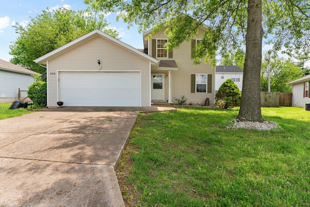 traditional-style home with concrete driveway, a garage, a front lawn, and fence