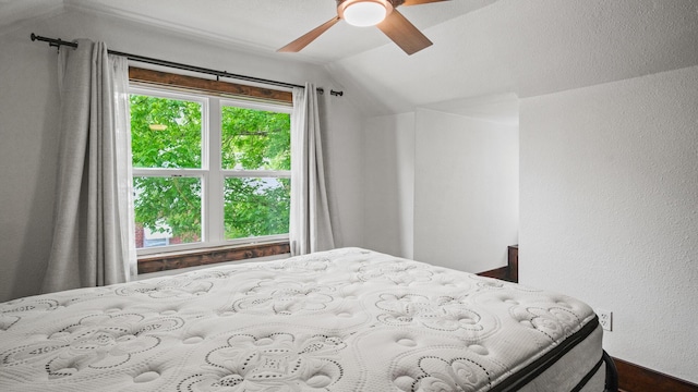 bedroom featuring lofted ceiling and a ceiling fan