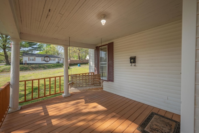 deck featuring a yard and a porch