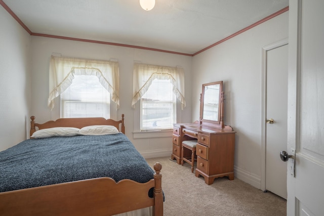 bedroom featuring light colored carpet, ornamental molding, and baseboards
