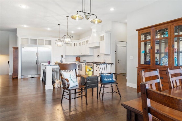 dining area with baseboards, dark wood-style floors, and recessed lighting