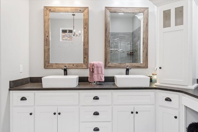 bathroom with a sink, double vanity, and a stall shower